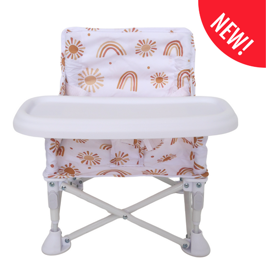 White baby high chair with orange sun and rainbow pattern on a white background