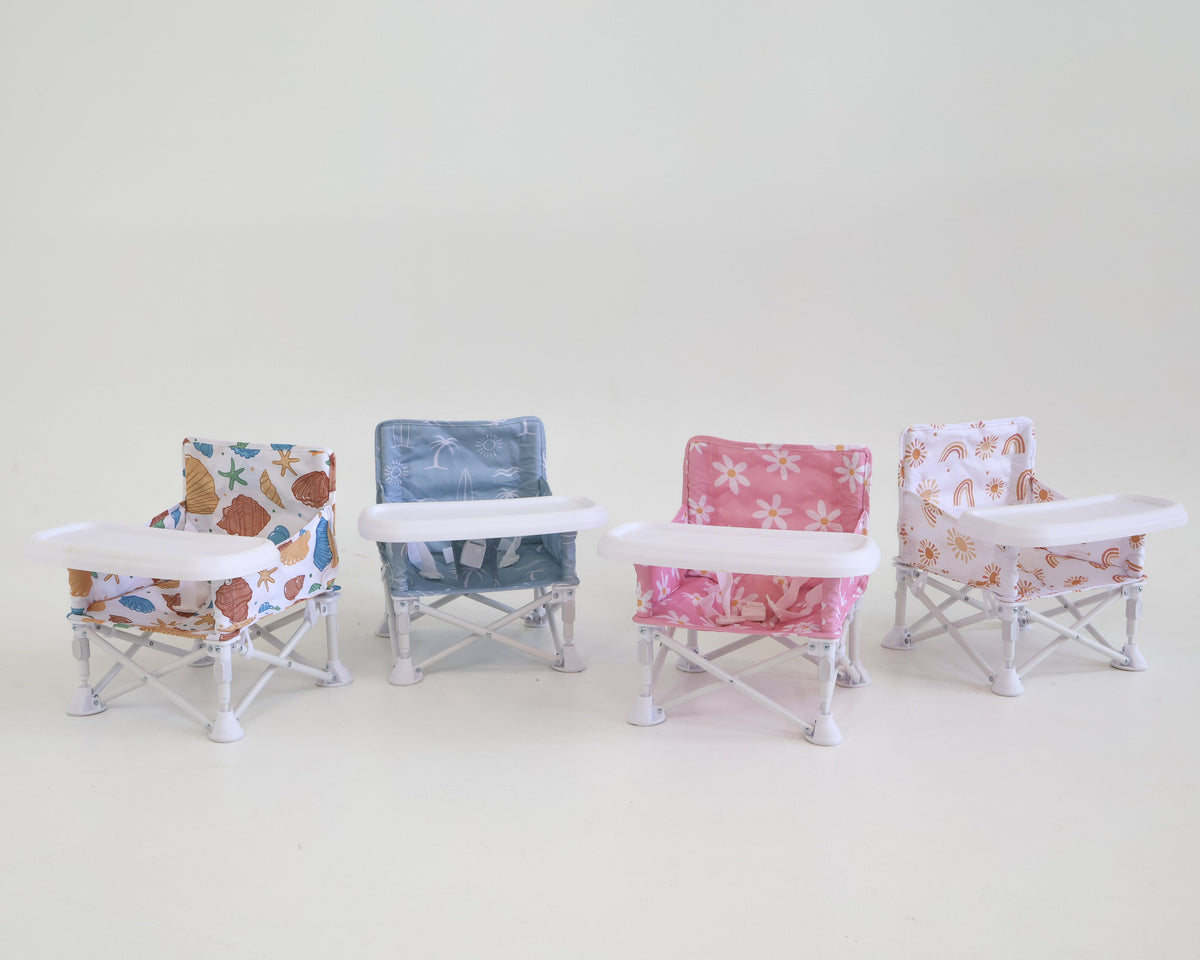 Four small chairs with floral patterns on a light gray background