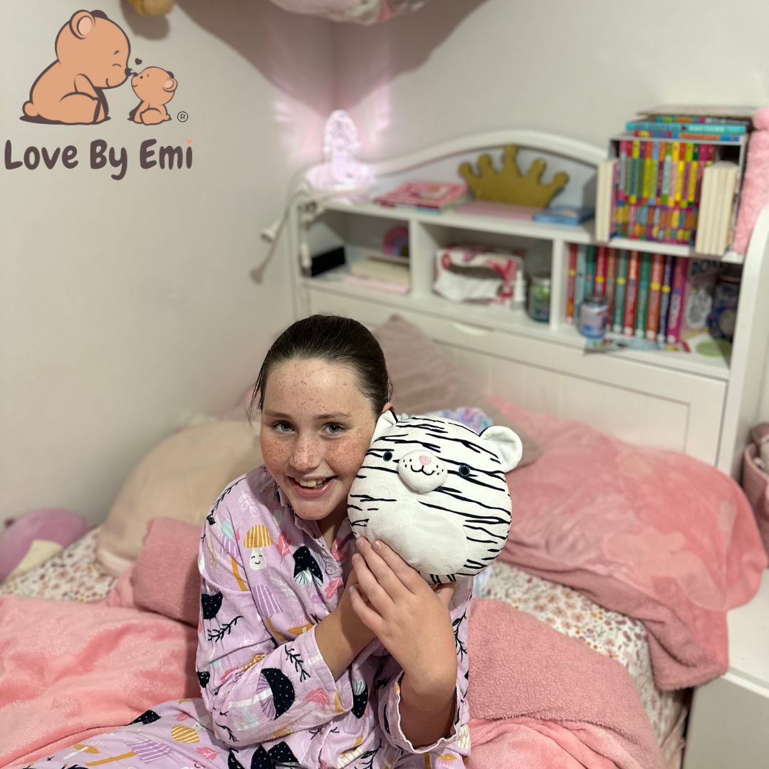 Product image of popular white tiger squishy made by love by emi held by cute girl sitting with her toys looking so happy with her new toy